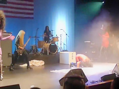 Painted boobs bounce around on the stage at a rock concert