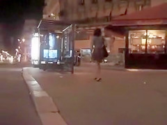Pretty woman in a dress pisses in public