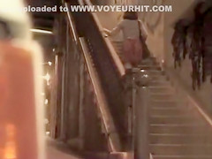 Pretty woman in a dress pisses in public