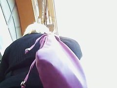 Slutty blonde in sexy stockings followed by an upskirt