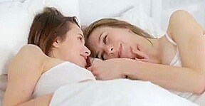 Two kittens playing on the bed