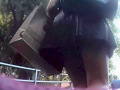Upskirt in the stairs of aleather skirt