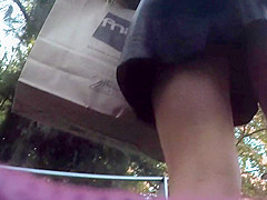 Upskirt in the stairs of aleather skirt