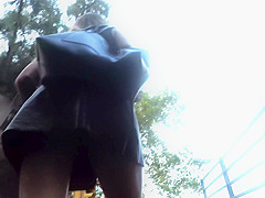 Upskirt in the stairs of aleather skirt