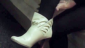 Woman takes off white sock to reveal her bandaged ankle