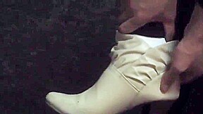 Woman takes off white sock to reveal her bandaged ankle