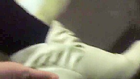 Woman takes off white sock to reveal her bandaged ankle