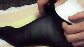 Woman takes off white sock to reveal her bandaged ankle
