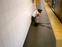 coed relieves herself at a metro station