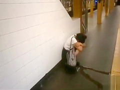 coed relieves herself at a metro station
